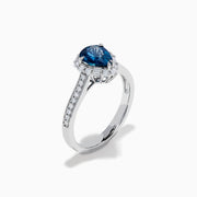 The Effy Hematian 18K White Gold Ring features a pear-shaped blue sapphire, surrounded by a halo of diamonds and set on a diamond-studded band, elegantly displayed against a white background.