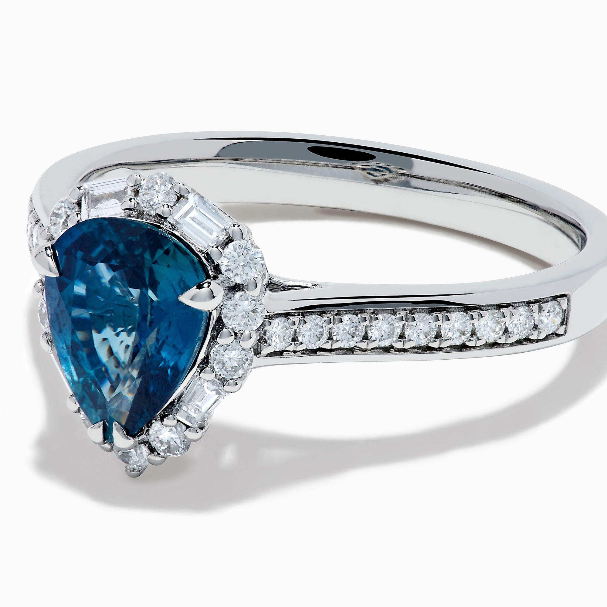The Effy Hematian 18K White Gold Ring features a pear-shaped blue sapphire, surrounded by a halo of diamonds and set on a diamond-studded band, elegantly displayed against a white background.