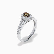 The Effy Hematian 18K White Gold Oval Alexandrite and Diamond Halo Ring features a central oval alexandrite surrounded by clear diamond accents in a halo and along the split shank band.