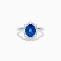 The Effy Hematian 14K White Gold Blue Sapphire and Diamond Halo Ring showcases an oval blue sapphire center, surrounded by a halo of sparkling round white diamonds, presented against a white background.