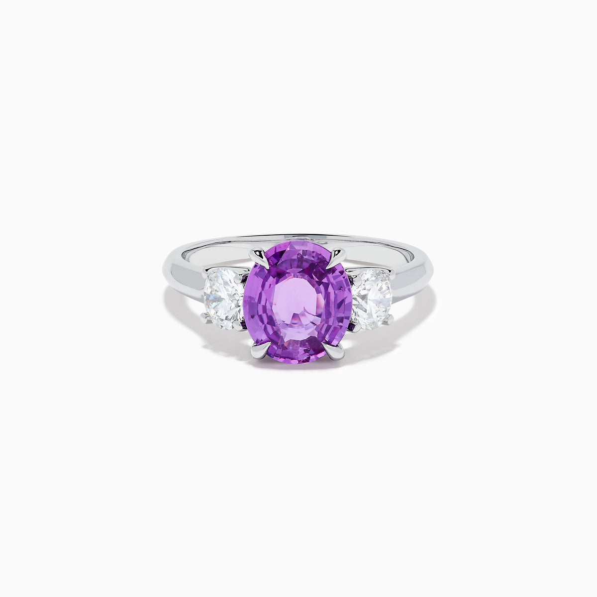 The Effy Hematian 18K White Gold Purple Sapphire and Diamond Three-Stone Ring features a large oval purple sapphire at the center with two smaller diamonds, shown on a white background.