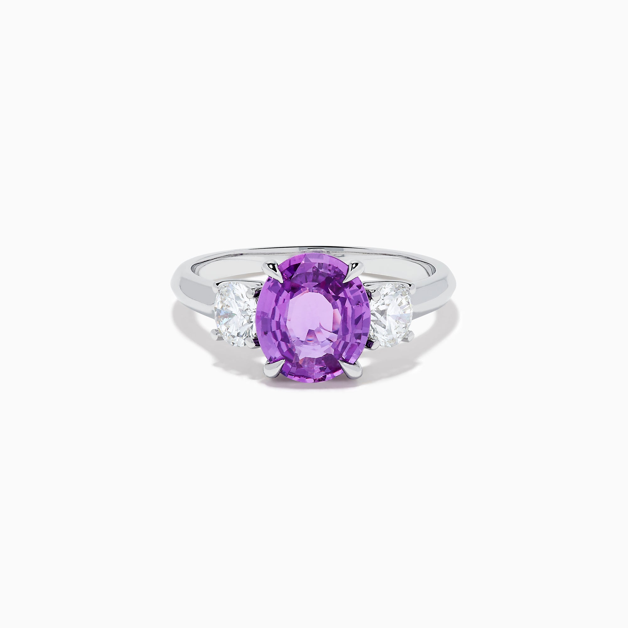 The Effy Hematian 18K White Gold Purple Sapphire and Diamond Three-Stone Ring features a large oval purple sapphire at the center with two smaller diamonds, shown on a white background.
