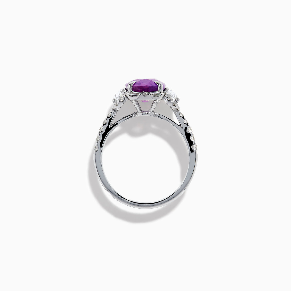 The Effy Hematian 18K White Gold Oval Purple Sapphire and Diamond Halo Ring features a central oval purple sapphire, two oval white diamonds, and smaller diamonds along the band, displayed on a white background.