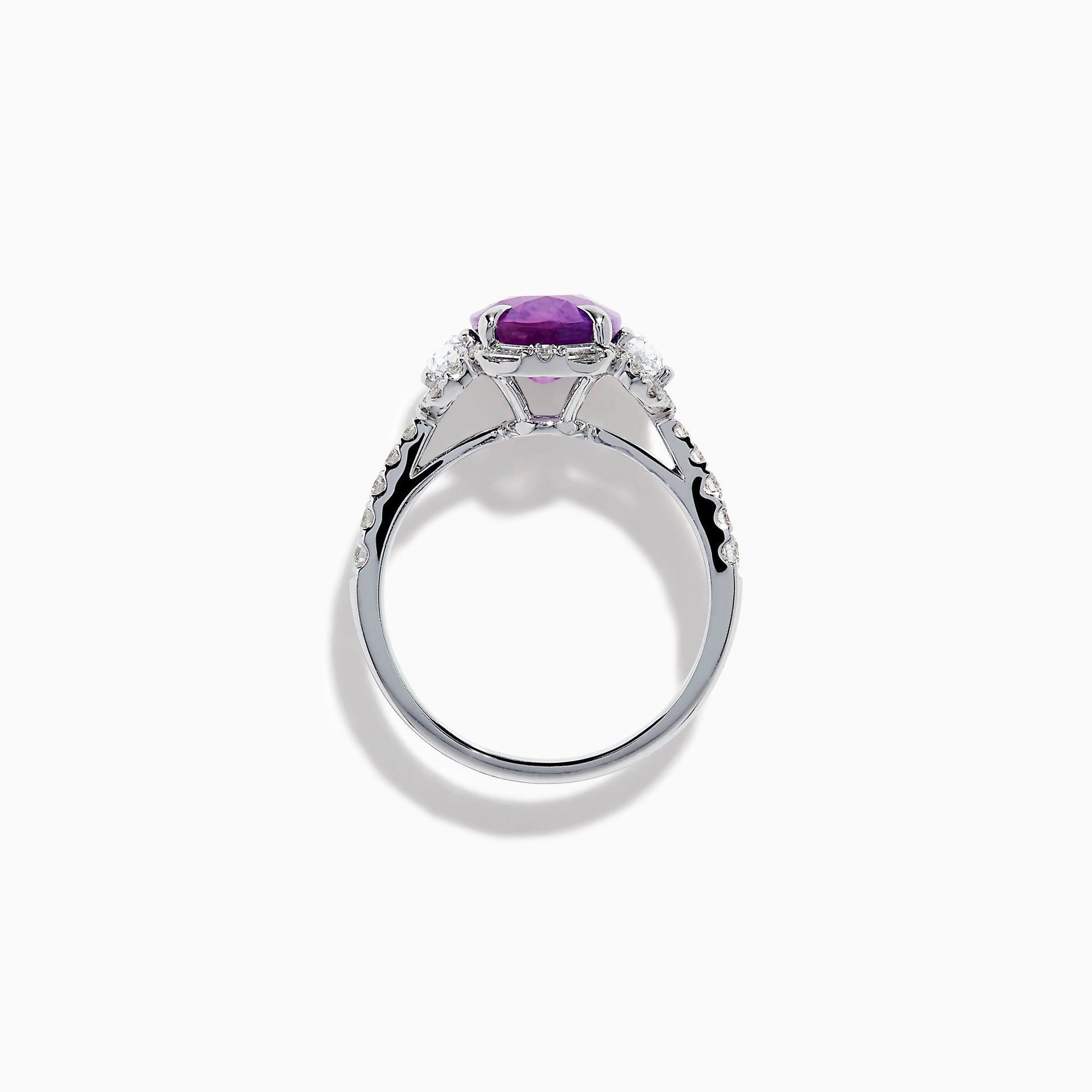 The Effy Hematian 18K White Gold Oval Purple Sapphire and Diamond Halo Ring features a central oval purple sapphire, two oval white diamonds, and smaller diamonds along the band, displayed on a white background.