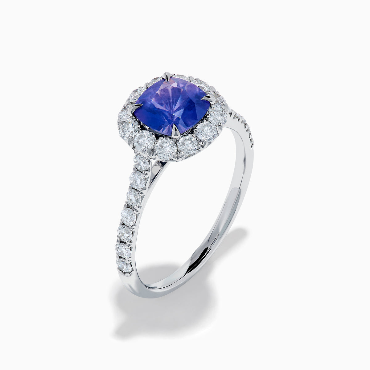 The Effy Hematian 18K White Gold Purple Sapphire and Diamond Halo Ring features a stunning round purple sapphire at the center, surrounded by sparkling diamonds with additional diamond accents along the band.