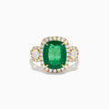 The Effy Hematian 18K Yellow Gold Emerald and Diamond Three Stone Ring features a large cushion-cut emerald, haloed by round white diamonds and accented with diamond clusters for a modern twist on the classic three stone style.