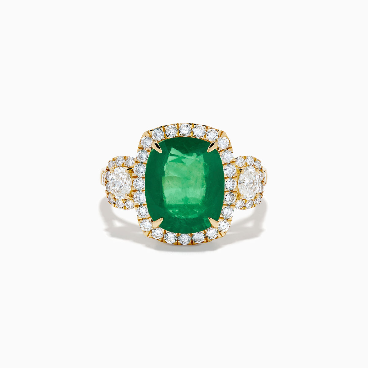 The Effy Hematian 18K Yellow Gold Emerald and Diamond Three Stone Ring features a large cushion-cut emerald, haloed by round white diamonds and accented with diamond clusters for a modern twist on the classic three stone style.