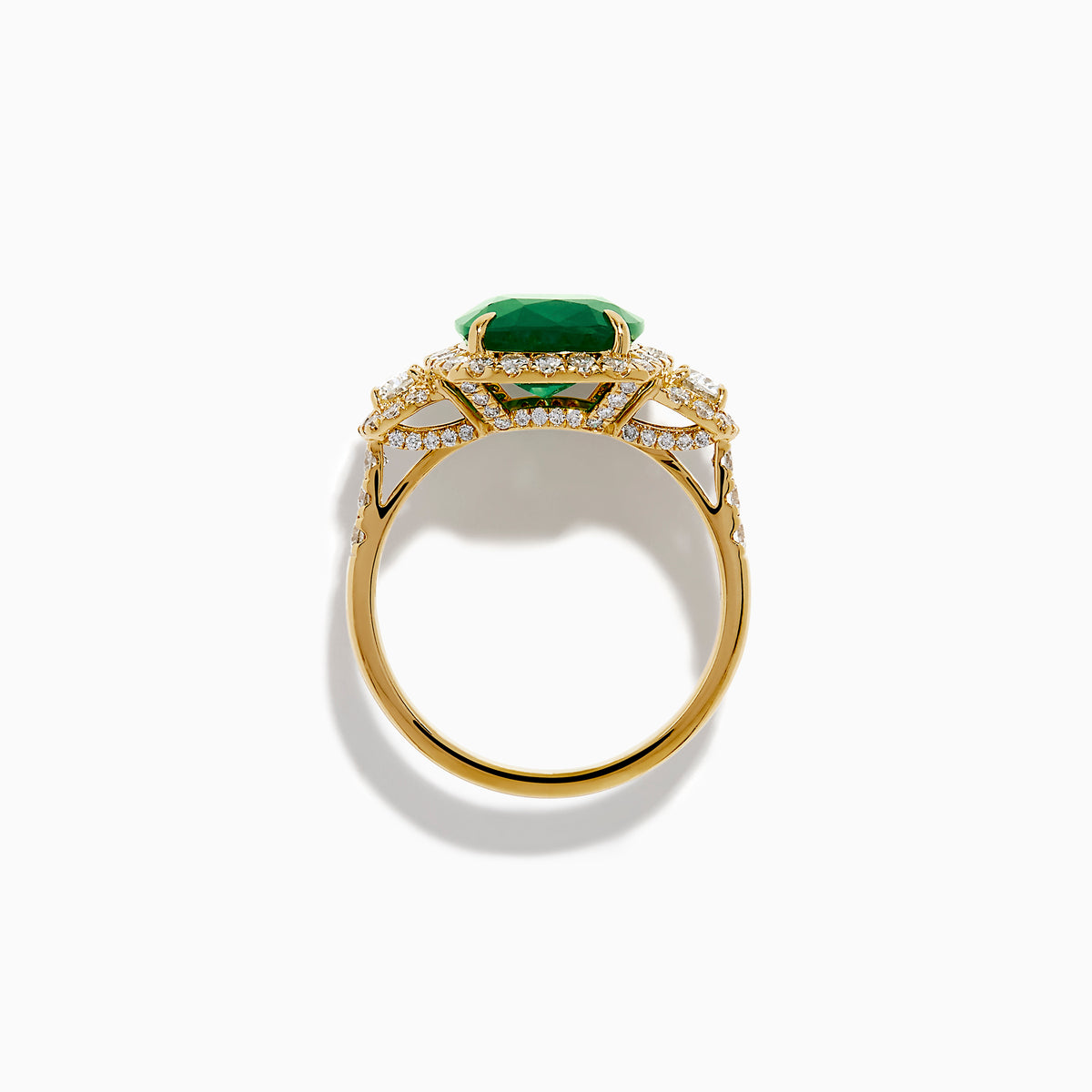 The Effy Hematian 18K Yellow Gold Emerald and Diamond Three Stone Ring features a large cushion-cut emerald, haloed by round white diamonds and accented with diamond clusters for a modern twist on the classic three stone style.