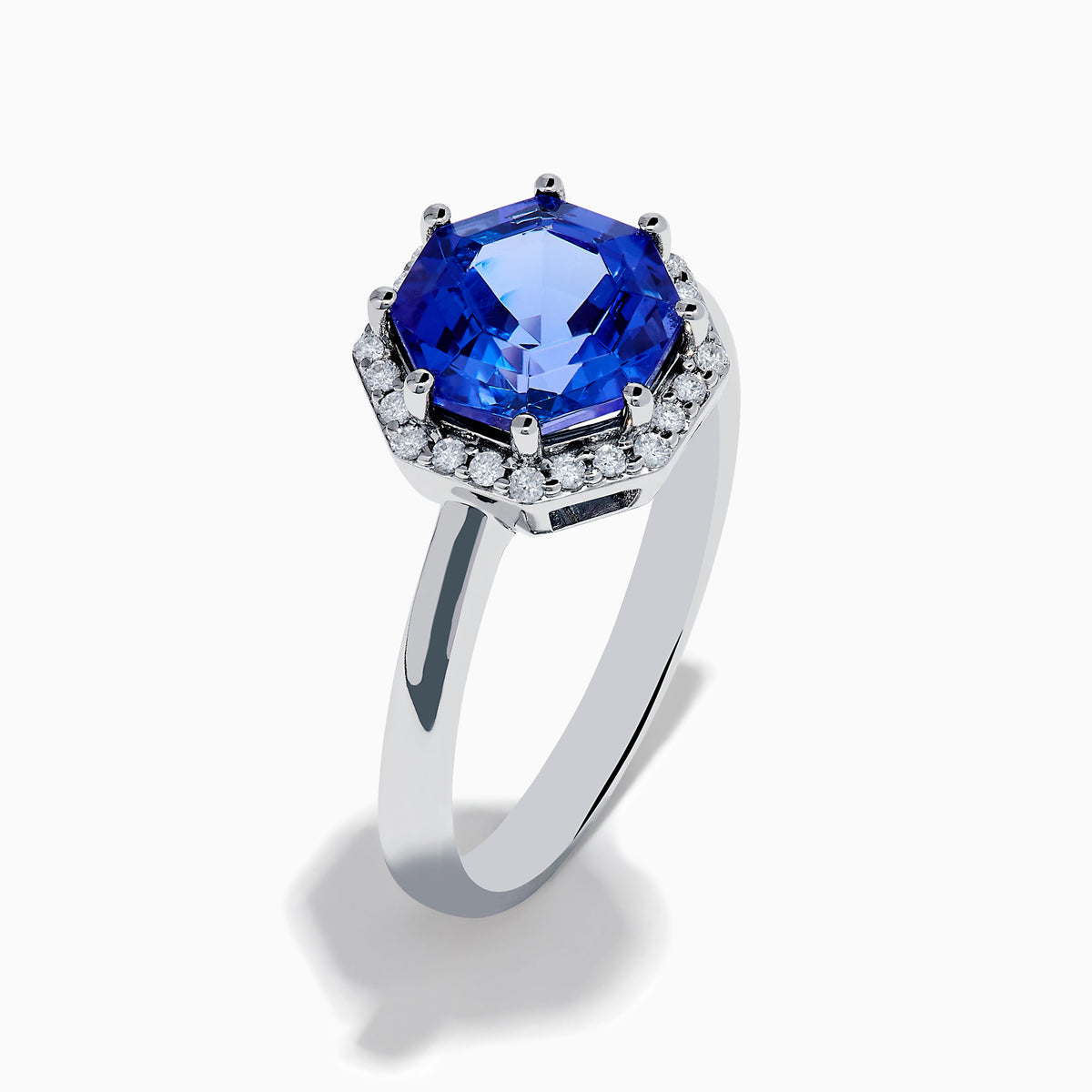 The Nahla Siri 14K Gold Octagon Cut Tanzanite and Diamond Ring showcases a large octagon-cut tanzanite at the center, bordered by sparkling diamonds, shown against a white background.