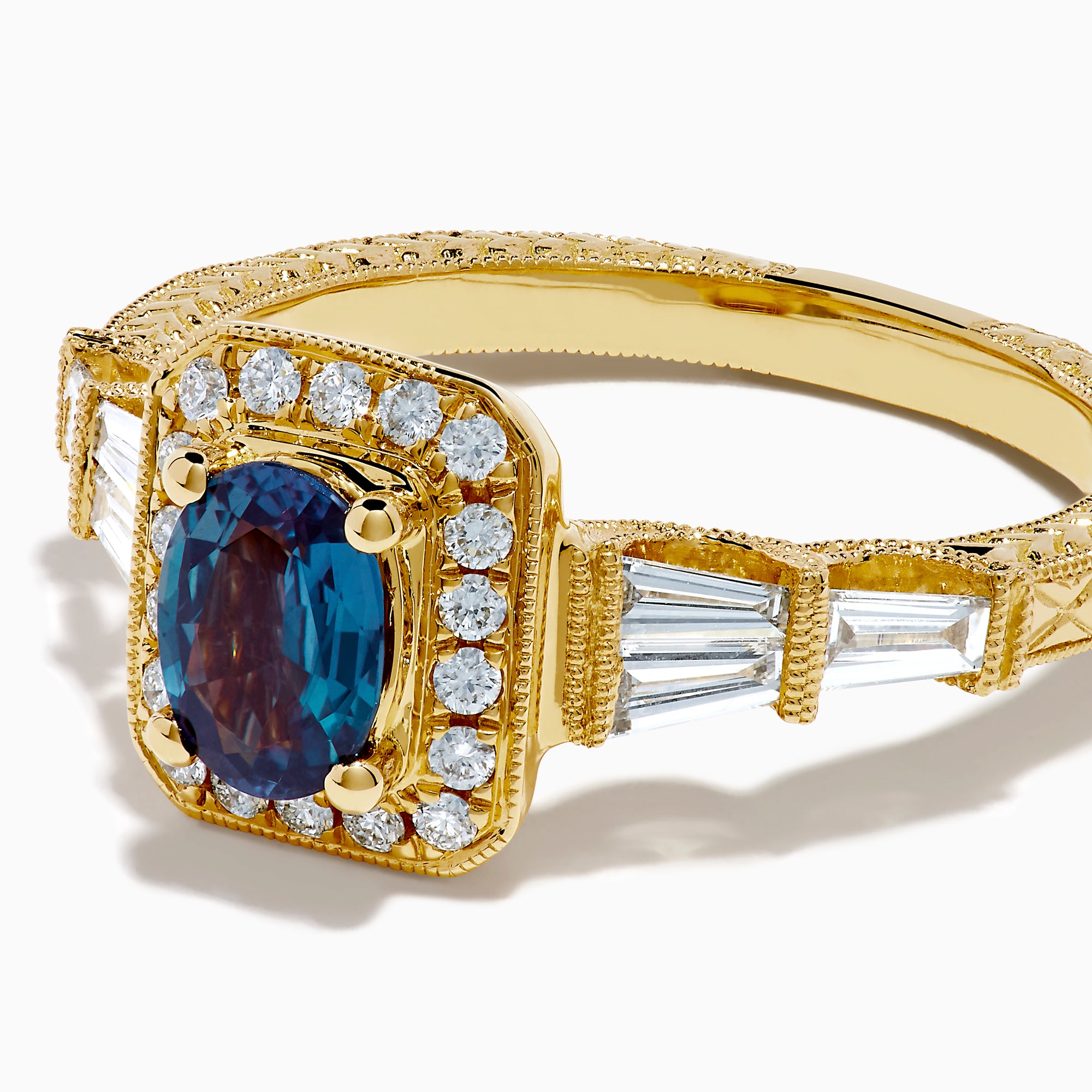 The 18K Yellow Gold GIA Certified Alexandrite and Diamond Halo Ring features a rectangular, iridescent center stone with a diamond halo and diamonds on the band, shown against a white background.