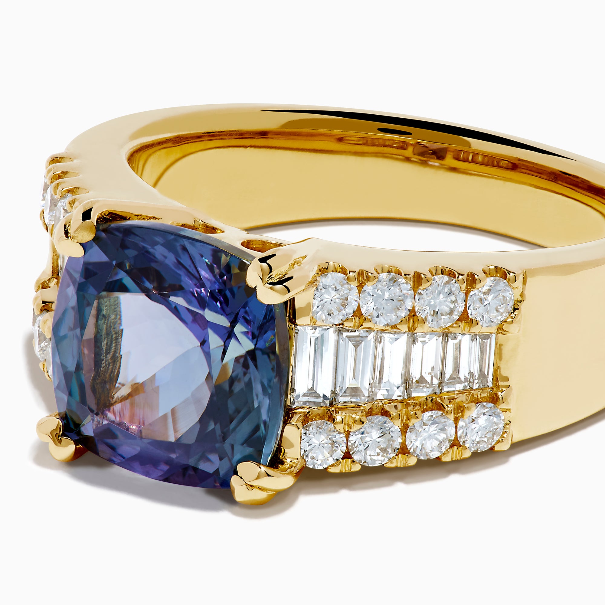 The 18K Yellow Gold GIA Certified Zoisite and Diamond Ring showcases a large square-cut zoisite center stone with rows of round and rectangular diamonds on each side, all set in elegant yellow gold.