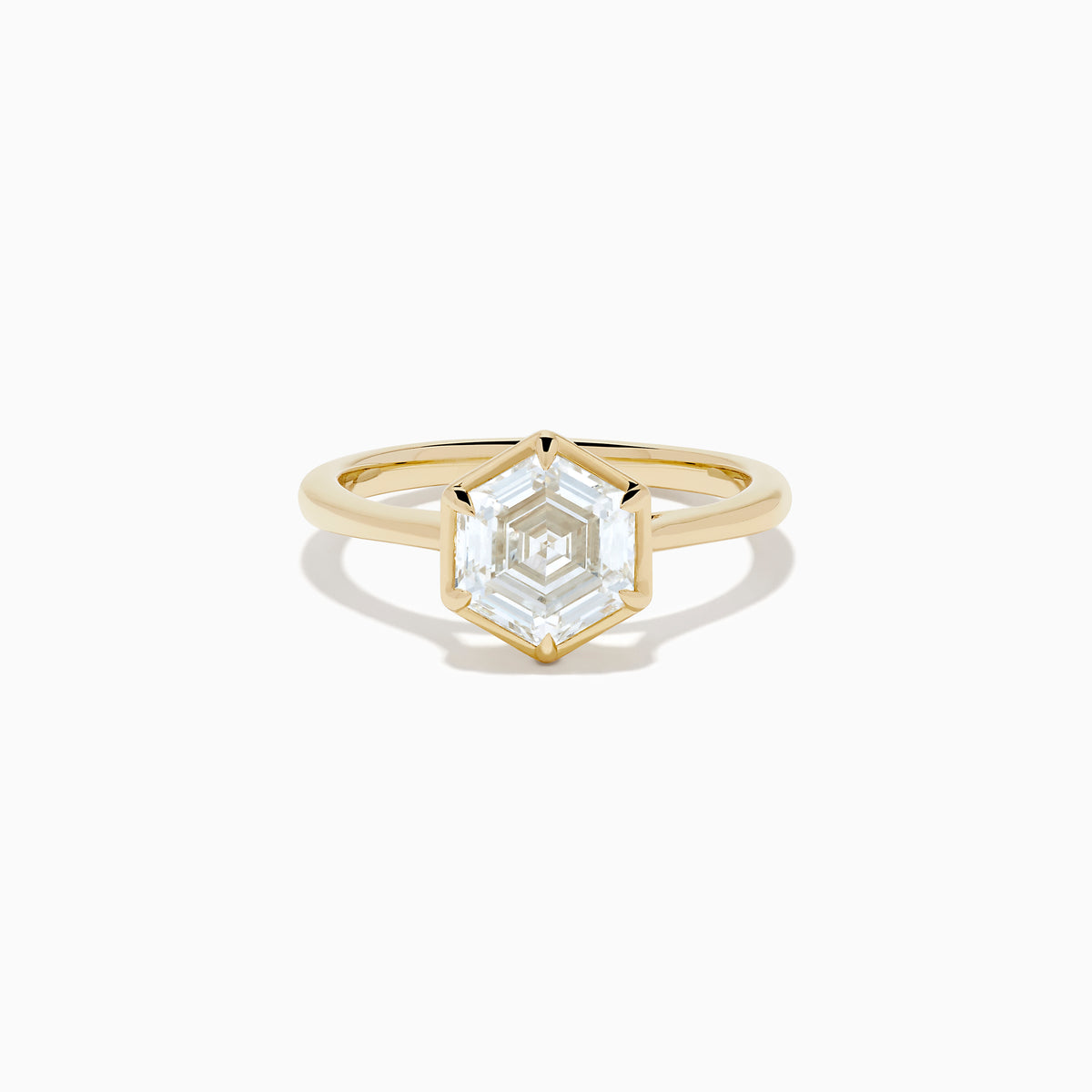 The Lab Grown Diamond 2.00ct Hexagon Solitaire Ring in 14K Yellow Gold showcases a hexagon-shaped, lab grown diamond with a geometric stepped cut, set on a sleek, polished gold band and displayed against a white background.