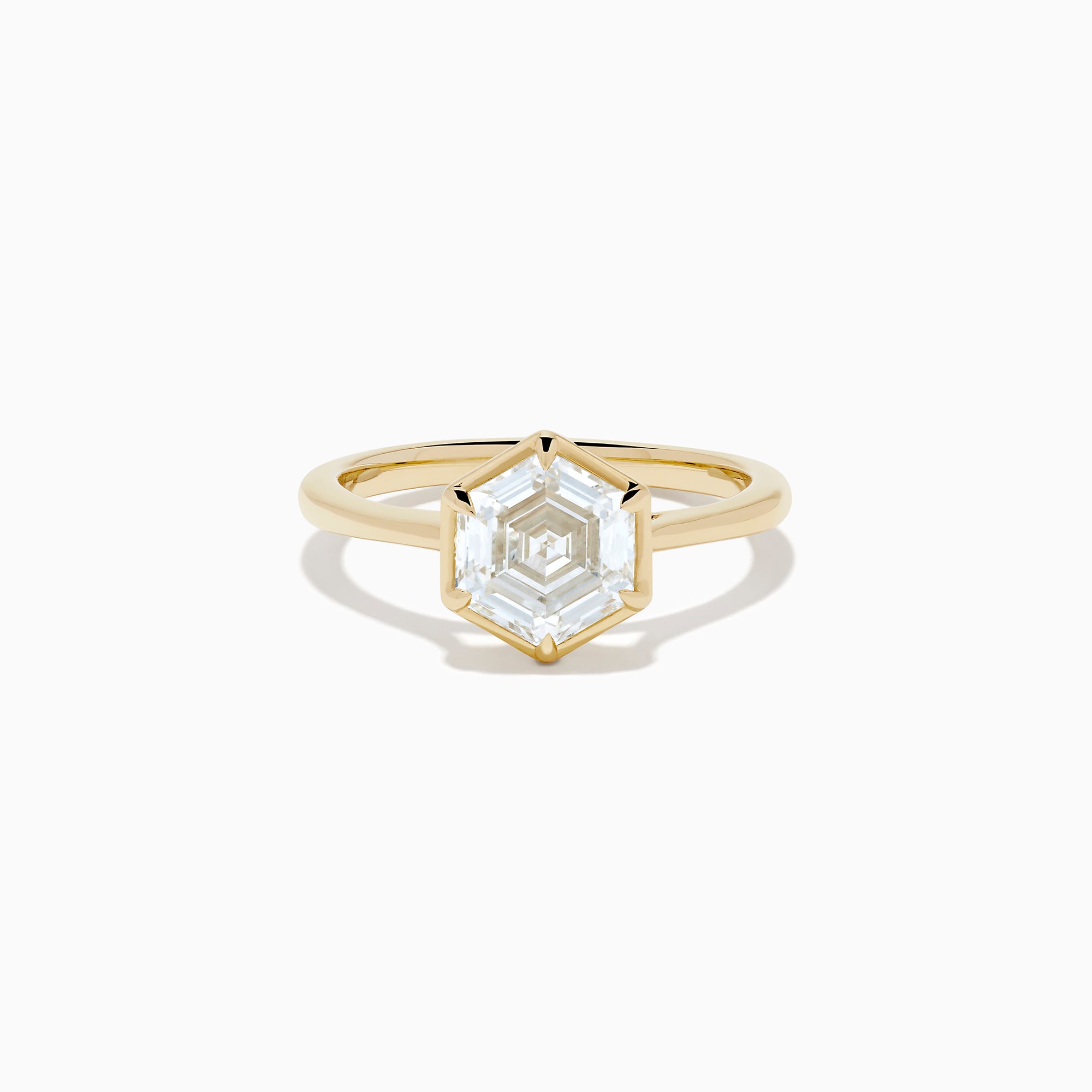 The Lab Grown Diamond 2.00ct Hexagon Solitaire Ring in 14K Yellow Gold showcases a hexagon-shaped, lab grown diamond with a geometric stepped cut, set on a sleek, polished gold band and displayed against a white background.