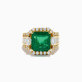 The 18K Yellow Gold Emerald and Diamond Ring features a large square green emerald center, encircled by round and baguette-cut white diamonds along the band and around the emerald, set against a white background.