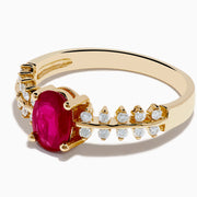 The 14K Yellow Gold Ruby and Diamond Ring features a central oval ruby accented by two rows of small round diamonds on each side, creating a sophisticated and elegant look.