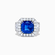 The Royale Bleu 18K White Gold Blue Sapphire and Diamond Halo Ring showcases a cushion-cut blue sapphire center with a double diamond halo and diamond side accents, elegantly set against a white background.