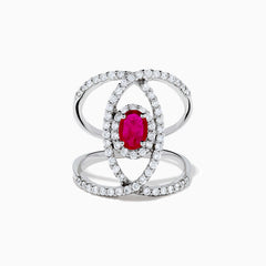 The Ruby Royale 14K White Gold Ruby and Diamond Ring features a central oval ruby with intersecting diamond-encrusted bands, beautifully set against a plain white background.