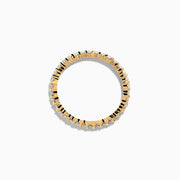 The 14K Yellow Gold Prong Set Diamond Eternity Band, 0.50 TCW, features a continuous row of oval-cut diamonds and is photographed on a plain white background.