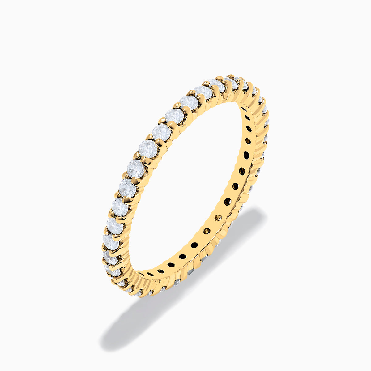 The 14K Yellow Gold Prong Set Diamond Eternity Band, 0.50 TCW, features a continuous row of oval-cut diamonds and is photographed on a plain white background.