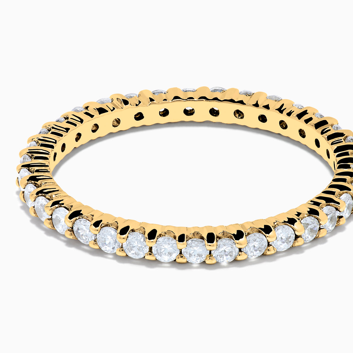 The 14K Yellow Gold Prong Set Diamond Eternity Band, 0.50 TCW, features a continuous row of oval-cut diamonds and is photographed on a plain white background.