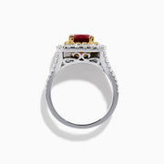 The 18K 2-Tone Gold Ruby, Yellow and White Diamond Double Halo Ring features a square ruby center, surrounded by yellow and white diamonds, set on a silver band with diamond accents.