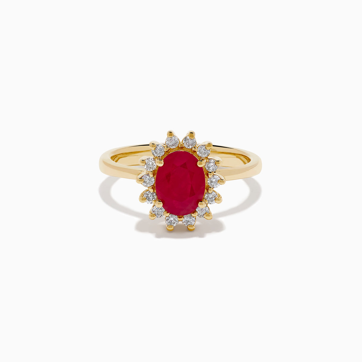 The 14K Yellow Gold Ruby and Diamond Halo Ring showcases an oval ruby center gemstone surrounded by a halo of round white diamonds, set in yellow gold and displayed against a white background.