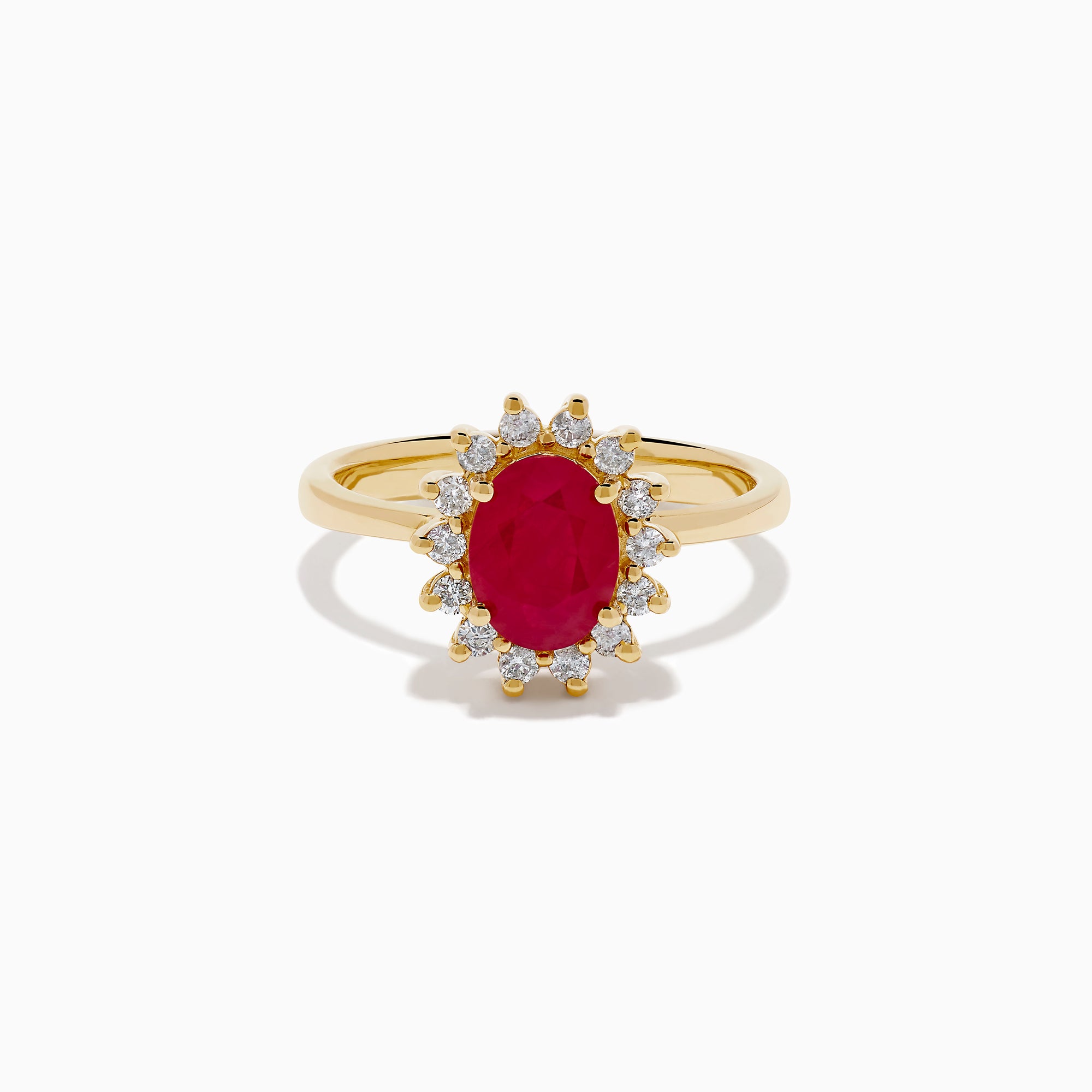 The 14K Yellow Gold Ruby and Diamond Halo Ring showcases an oval ruby center gemstone surrounded by a halo of round white diamonds, set in yellow gold and displayed against a white background.