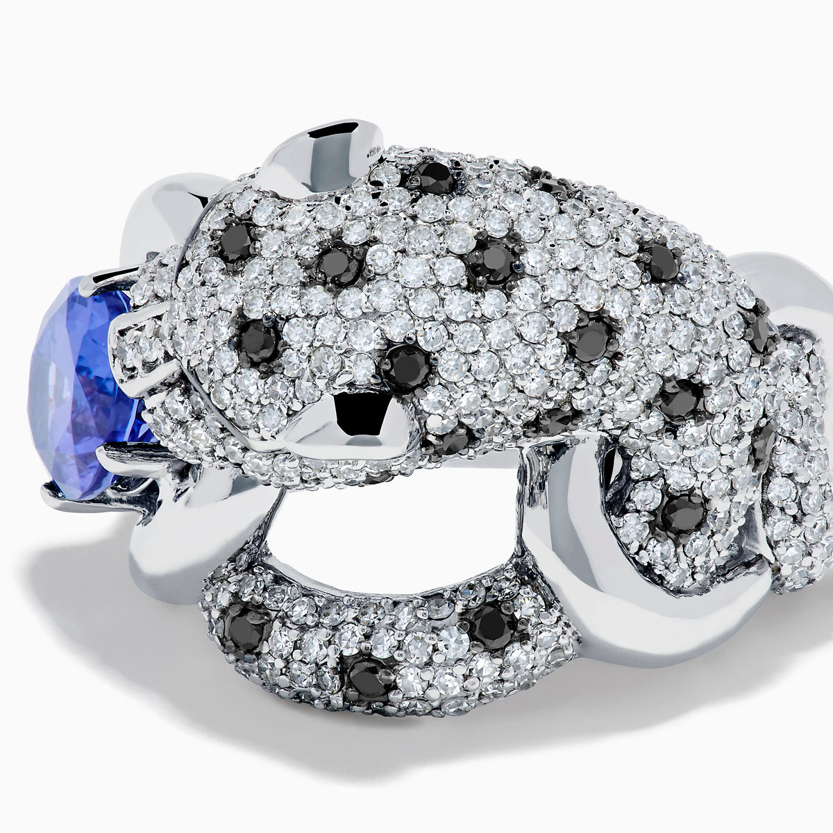 The Signature 14K White Gold Tanzanite and Diamond Panther Ring features diamond accents, green gemstone eyes, and a large oval tanzanite held in the panther's paws and mouth.