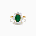 The 14K Yellow Gold Natural Emerald and Diamond Lady Di Ring showcases an oval emerald center surrounded by a halo of round white diamonds.