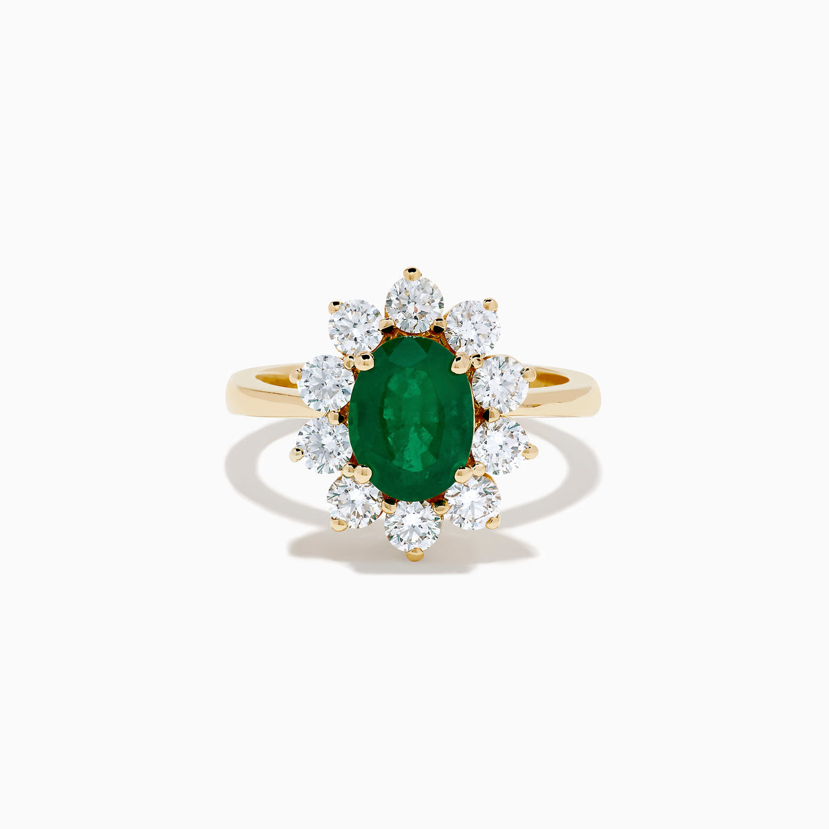 The 14K Yellow Gold Natural Emerald and Diamond Lady Di Ring showcases an oval emerald center surrounded by a halo of round white diamonds.