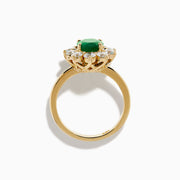 The 14K Yellow Gold Natural Emerald and Diamond Lady Di Ring showcases an oval emerald center surrounded by a halo of round white diamonds.