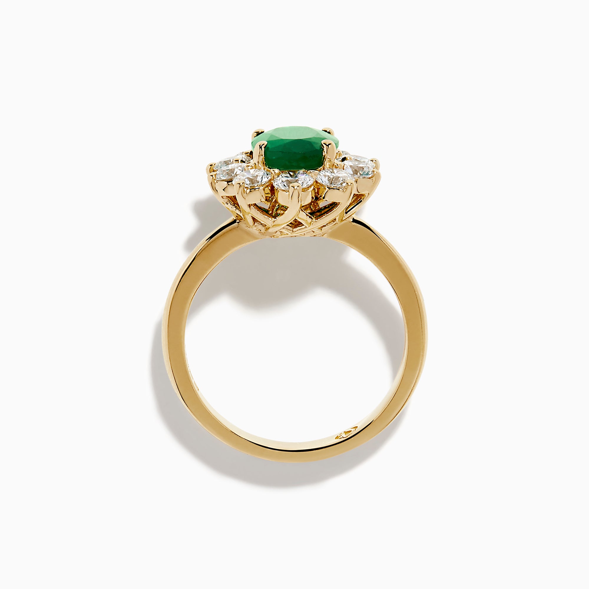 The 14K Yellow Gold Natural Emerald and Diamond Lady Di Ring showcases an oval emerald center surrounded by a halo of round white diamonds.