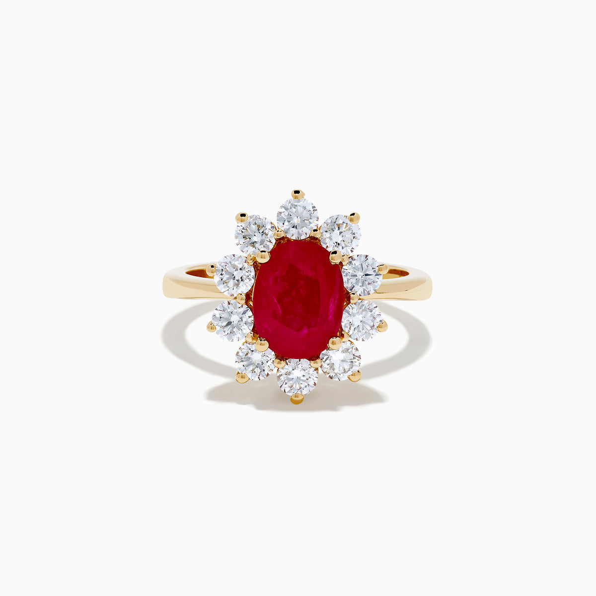 The 14K Yellow Gold Natural Ruby and Diamond Lady Di Ring showcases an oval natural ruby center with a halo of round white diamonds, set against a white background.