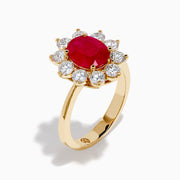 The 14K Yellow Gold Natural Ruby and Diamond Lady Di Ring showcases an oval natural ruby center with a halo of round white diamonds, set against a white background.