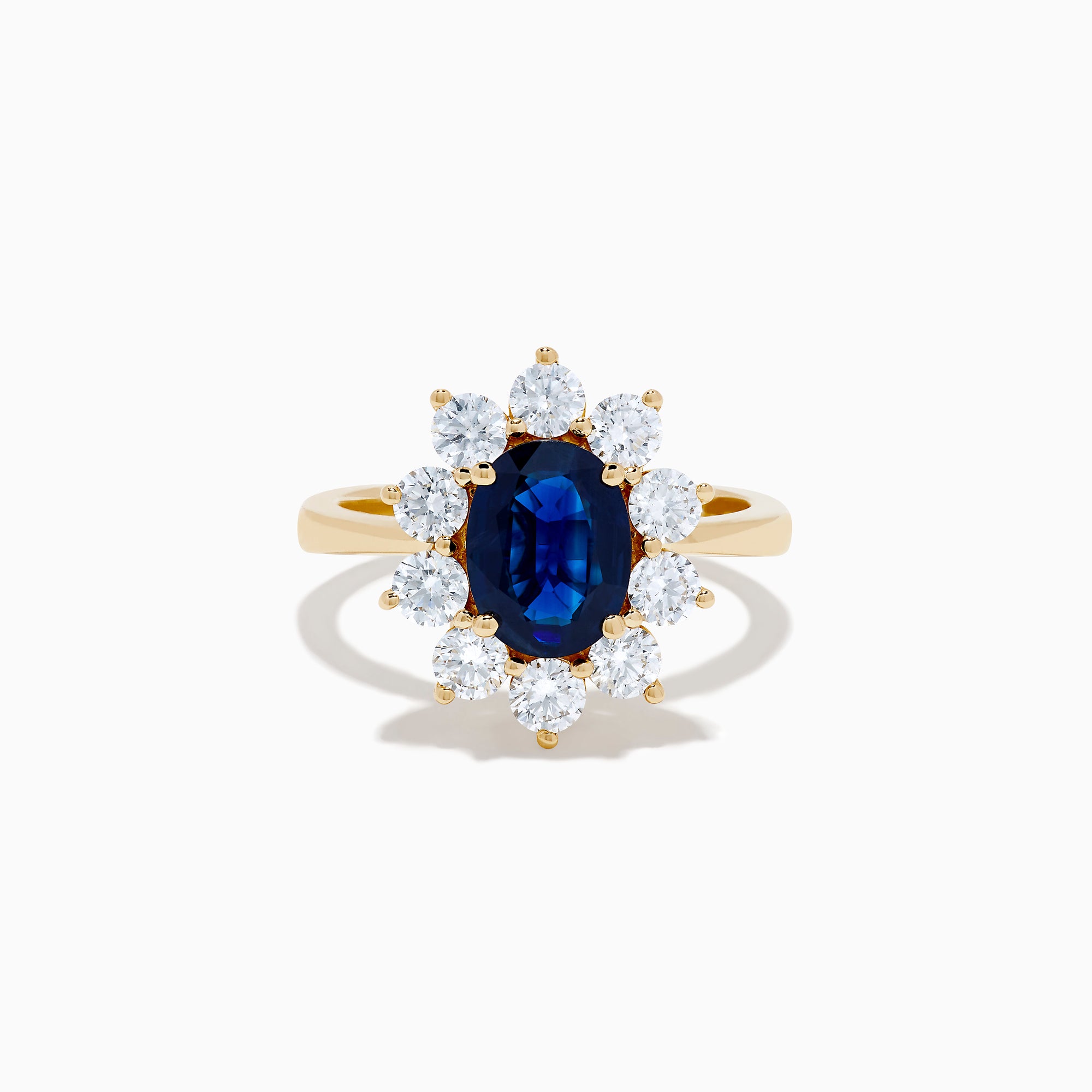 The 14K Yellow Gold Natural Blue Sapphire and Diamond Lady Di Ring features an oval sapphire center, haloed by round white diamonds, shown on a white background.