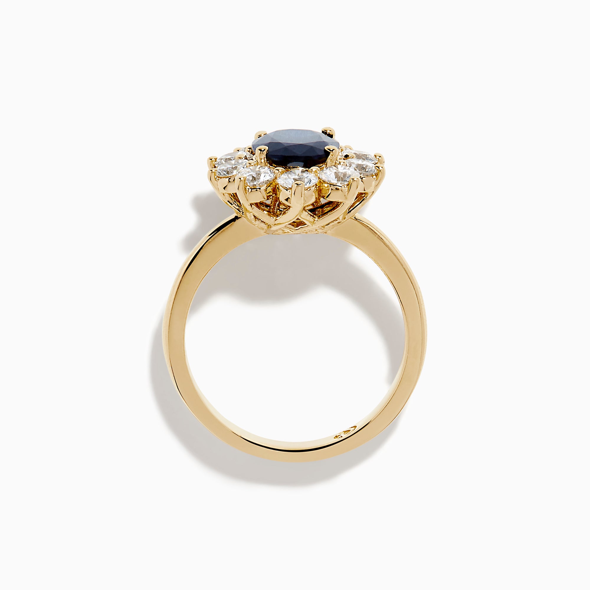 The 14K Yellow Gold Natural Blue Sapphire and Diamond Lady Di Ring features an oval sapphire center, haloed by round white diamonds, shown on a white background.