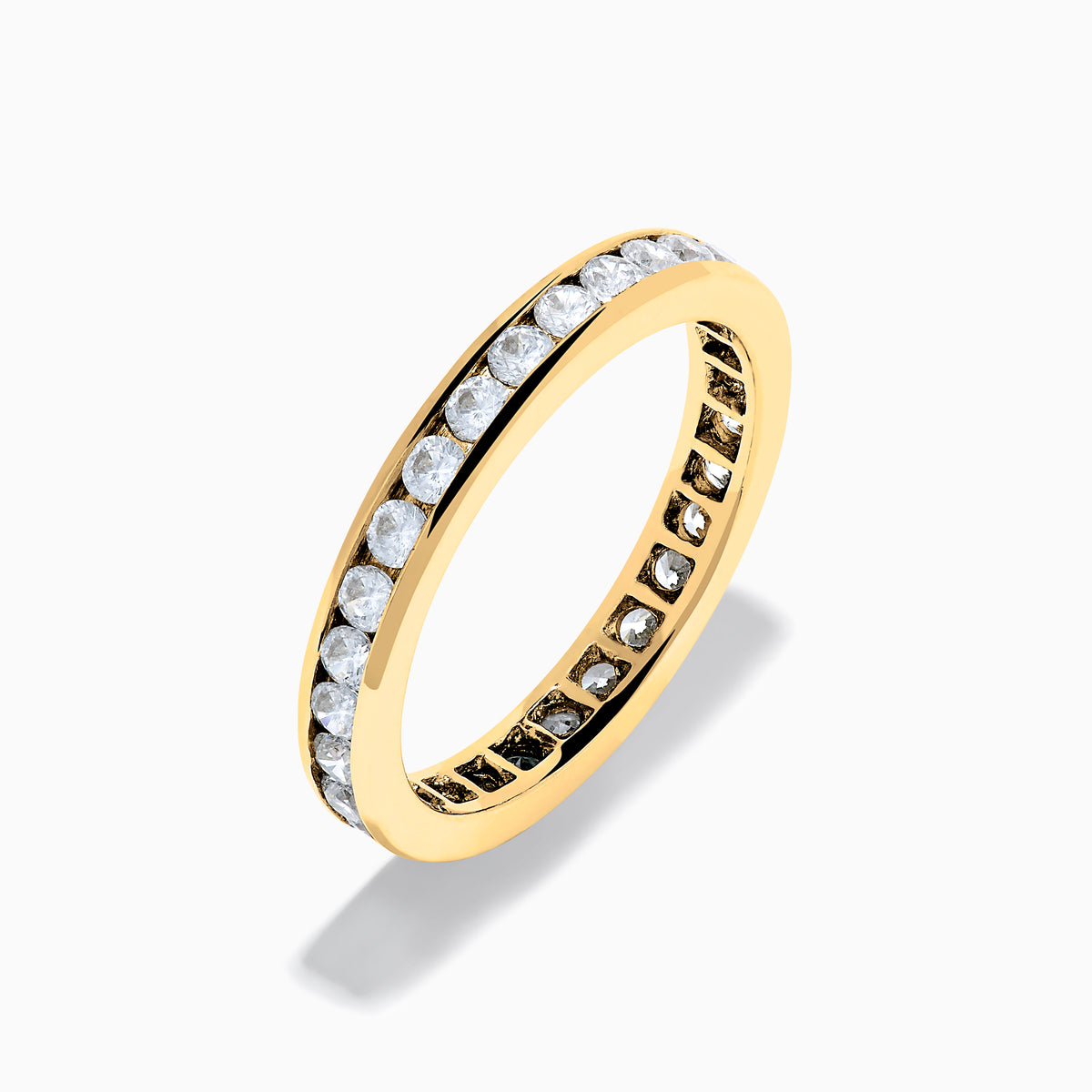 The 14K Yellow Gold Channel Set Diamond Eternity Band, 1.00 TCW, showcases a continuous row of round white diamonds in a channel setting, displayed on a white background.