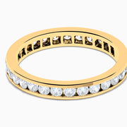 The 14K Yellow Gold Channel Set Diamond Eternity Band, 1.00 TCW, showcases a continuous row of round white diamonds in a channel setting, displayed on a white background.