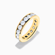 The 14K Yellow Gold Channel Set Diamond Eternity Band, 3.00 TCW, features round diamonds encircling the band and is displayed on a white background.