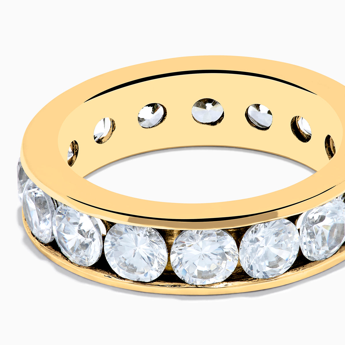 The 14K Yellow Gold Channel Set Diamond Eternity Band, 4.00 TCW, showcases large round diamonds in a continuous channel setting around the band, elegantly displayed on a white background.