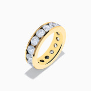 A 14K Yellow Gold Channel Set Diamond Eternity Band, 5.00 TCW, featuring round diamonds all around, displayed on a plain white background.