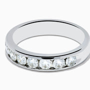 The 14K White Gold 10-Stone Channel Set Diamond Band, 1.00 TCW, features a row of sparkling round diamonds set along the top half and is displayed on a plain white background.