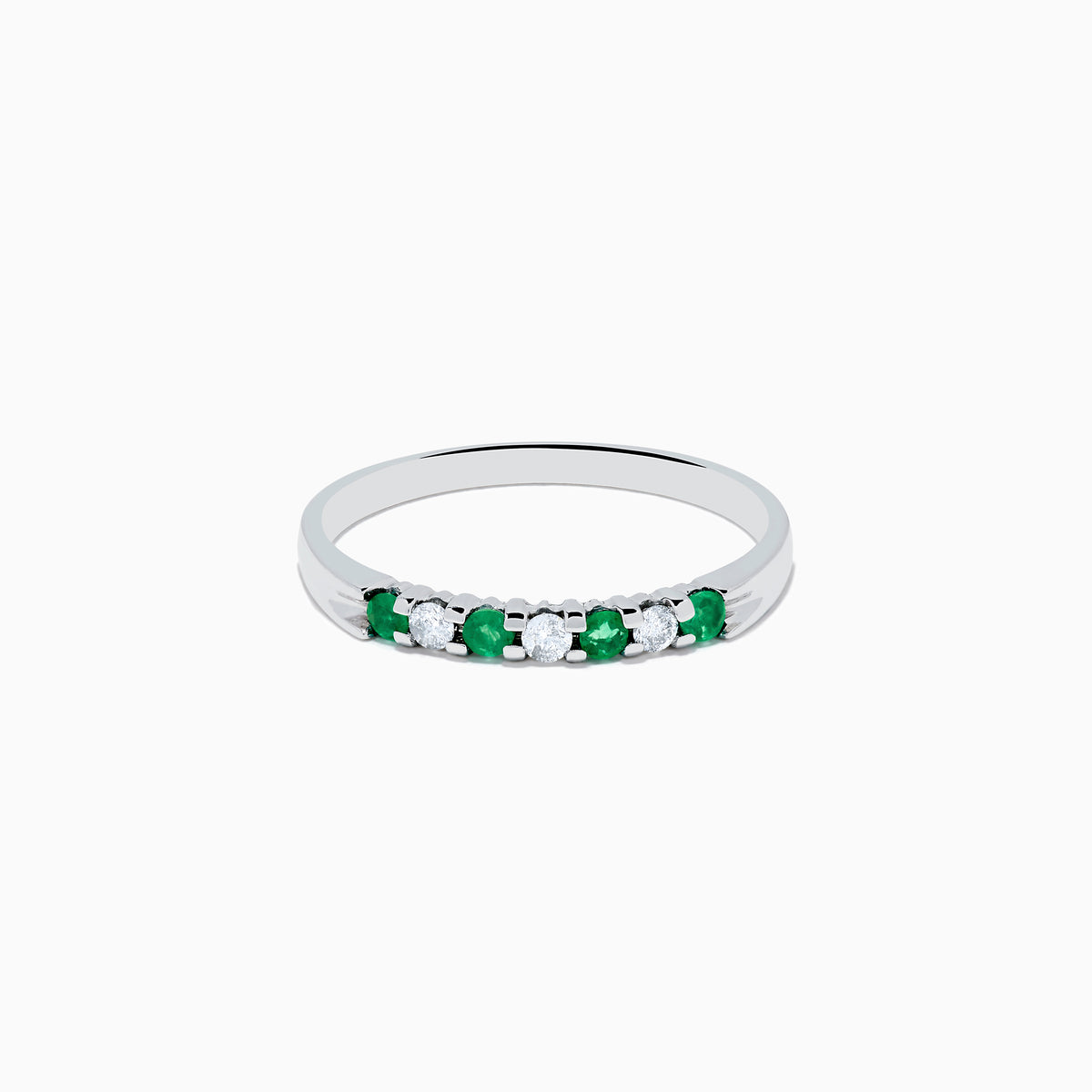 The 14K White Gold 7-Stone Emerald & Diamond Band, 0.25 TCW, showcases alternating round emeralds and diamonds set in a row along the band, displayed on a plain white background.