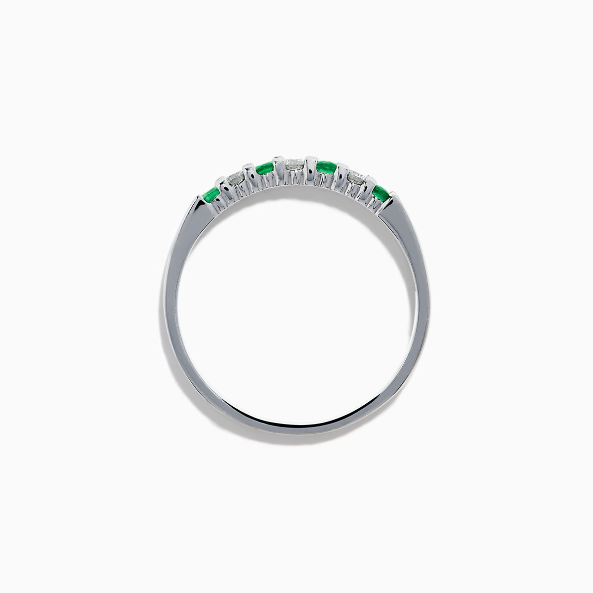 The 14K White Gold 7-Stone Emerald & Diamond Band, 0.25 TCW, showcases alternating round emeralds and diamonds set in a row along the band, displayed on a plain white background.