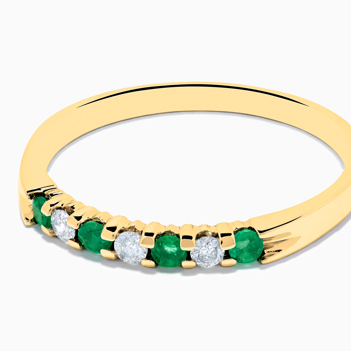The 14K Yellow Gold 7-Stone Emerald & Diamond Band, 0.25 TCW, features alternating round white diamonds and emeralds set in a row on the band, shown against a white background.
