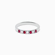 The 14K White Gold 7-Stone Ruby & Diamond Band, 0.25 TCW, showcases alternating vivid red rubies and sparkling round white diamonds set in a row along the band, shown on a white background.