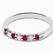 The 14K White Gold 7-Stone Ruby & Diamond Band, 0.25 TCW, showcases alternating vivid red rubies and sparkling round white diamonds set in a row along the band, shown on a white background.