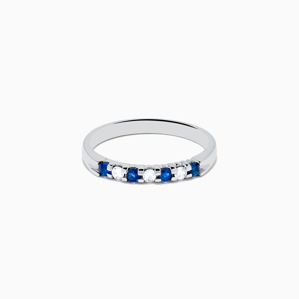 A 14K white gold band featuring alternating blue sapphires and diamonds (0.25 TCW), displayed against a white background.