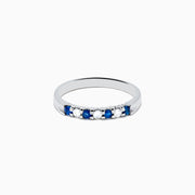 A 14K white gold band featuring alternating blue sapphires and diamonds (0.25 TCW), displayed against a white background.
