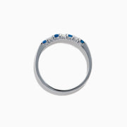 A 14K white gold band featuring alternating blue sapphires and diamonds (0.25 TCW), displayed against a white background.
